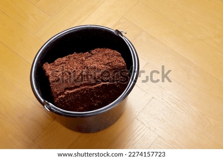 How to make cheap grow or potting soil from coco coir bricks, step 4: the rehydrated block has increased to about 3 to 4 times of its original volume. Royalty-Free Stock Photo #2274157723