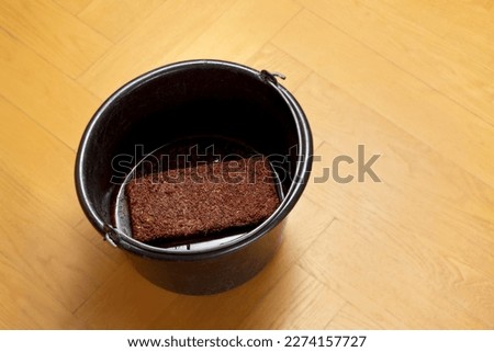 How to make cheap and eco-friendly grow or potting soil from coconut coir, step 3: let soak till all the water is absorbed by the expanding brick. Royalty-Free Stock Photo #2274157727