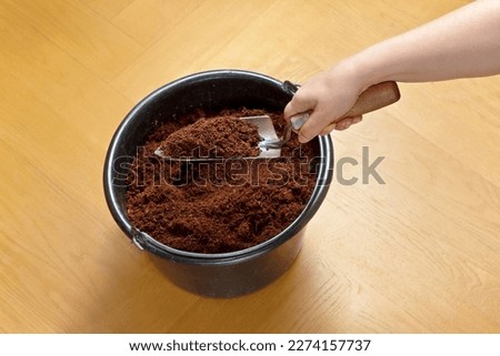 How to make cheap and eco-friendly soil from coco coir bricks, step 5: break up any left chunks with a trowel and use for potting or gardening. Royalty-Free Stock Photo #2274157737