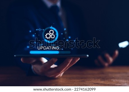 Operating system upgrade concept, installation app and software update process, modernize user equipment, update modern functions, developer released new version Improved security. User is downloading Royalty-Free Stock Photo #2274162099