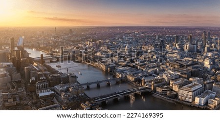 Panoramic view over the skyline of London city with Thames River, St. Pauls Cathedral, Blackfriars and Southwark during a golden sunset, England