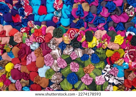 The decorative craft made from scraps of cloth or leftover fabric that are sewn or woven together is called a patchwork.