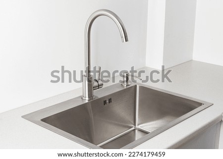 Modern kitchen faucet and sink Royalty-Free Stock Photo #2274179459
