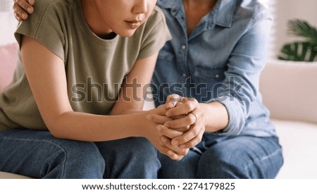 Middle aged asia people old mom holding hands trust comfort help young woman talk crying stress relief at home. Mum as friend love care hold hand adult child feel pain sad worry of life crisis issues. Royalty-Free Stock Photo #2274179825