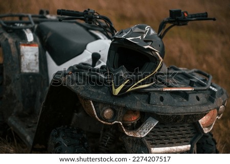 Close up view of ATV quad bike with protective helmet on it.