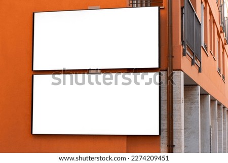 2 large-format billboards on top of each other on a street in Switzerland, in Ticino, Lugano