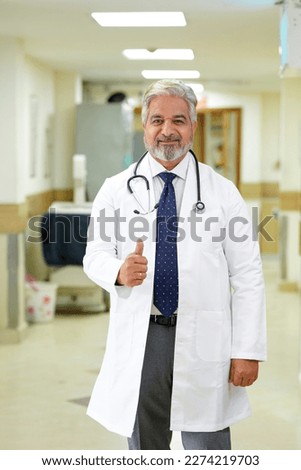 Indian male doctor showing thumps up at hospital. Royalty-Free Stock Photo #2274219703