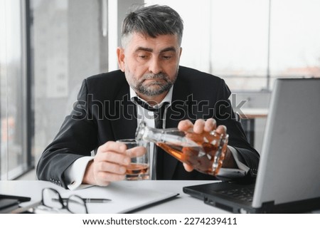 Old businessman drinking from stress Royalty-Free Stock Photo #2274239411