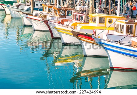 Colorful sailing boats at Fishermans Wharf marina pier in San Francisco Bay in California - Travel concept with wonderful destination in United States of America Royalty-Free Stock Photo #227424694