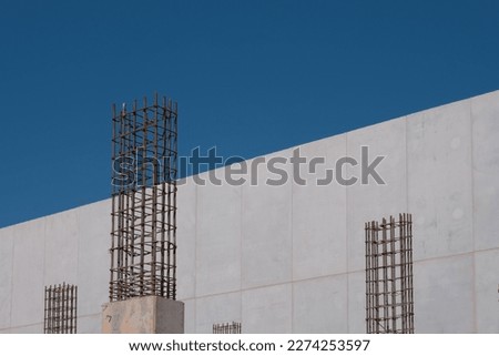 Rebar and pilings with new cement wall in Charlotte, NC. Royalty-Free Stock Photo #2274253597