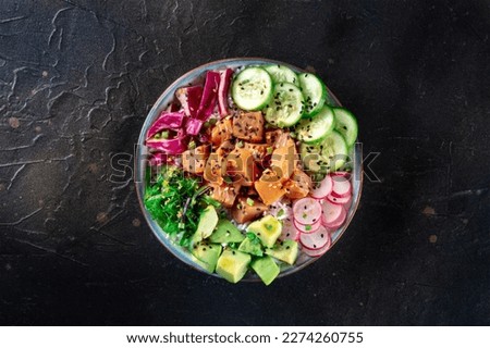 Tuna poke bowl with avocado, cucumbers, wakame, radish, and purple cabbage, a healthy Hawaiian dish with rice, overhead flat lay shot Royalty-Free Stock Photo #2274260755