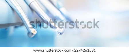 Closeup photo of dental handpieces and equipment on dental chair with blured background Royalty-Free Stock Photo #2274261531