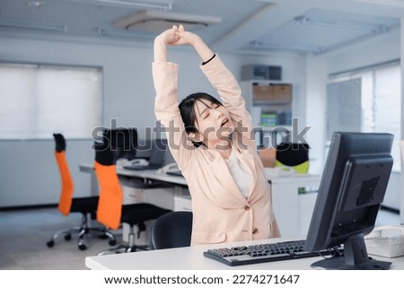 Tired businesswoman working overtime until morning Royalty-Free Stock Photo #2274271647