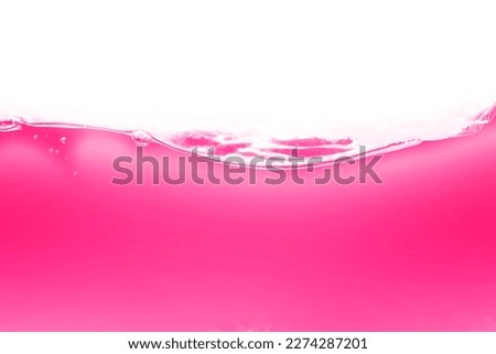 Drink clean pink water in a glass and the bubbles look like splashes and waves.	