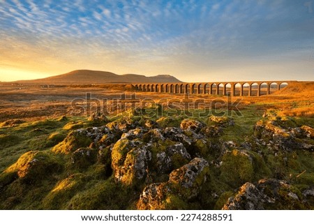 Golden morning light on Ribblehead Viaduct at sunrise.  Royalty-Free Stock Photo #2274288591