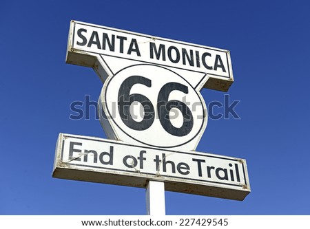 Historic U.S. Route 66 signpost in Santa Monica California, a road stretching from Chicago to Los Angeles which became synonymous with automobiles and driving itself. Royalty-Free Stock Photo #227429545