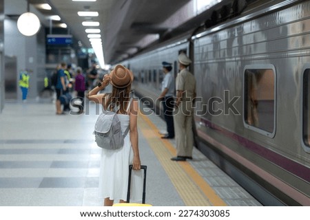 traveller woman walking at Krung Thep Aphiwat Central Terminal or Bang Sue Central station is the central passenger terminal in Bangkok and the current railway hub of Thailand with travel bag Royalty-Free Stock Photo #2274303085
