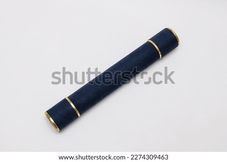 Diploma holder, in dark blue color, with golden details. White background. Royalty-Free Stock Photo #2274309463