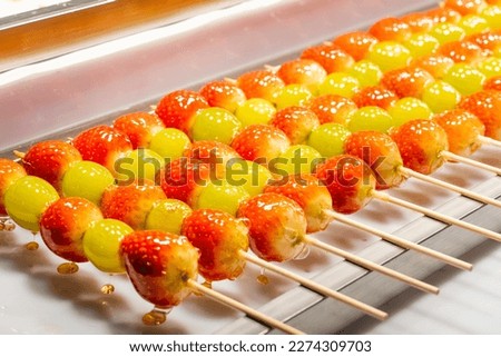 Strawberry sticks covered melted sugar food street in Korea Royalty-Free Stock Photo #2274309703