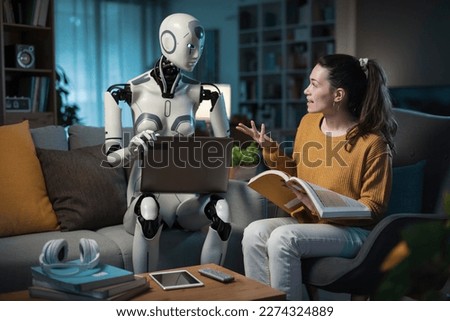 A female person enjoying her smart living room, studying with an AI droid companion and laptop. Royalty-Free Stock Photo #2274324889