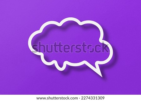 White paper cut out speech bubble shapes set on purple paper background. Royalty-Free Stock Photo #2274331309