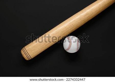 Wooden baseball bat and ball on black background, flat lay. Sports equipment