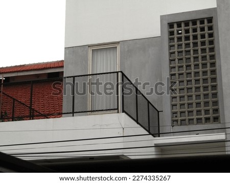Home Balcony  Corner Modern Minimalist Shades of White, Gray, Black with Checkered Details Photographed From Outside The House. Bright Sky.