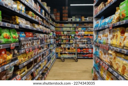 Blurred image of shelves with snacks in supermarket.