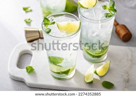 Classic mojito cocktail in tall glasses with lime and fresh mint Royalty-Free Stock Photo #2274352885