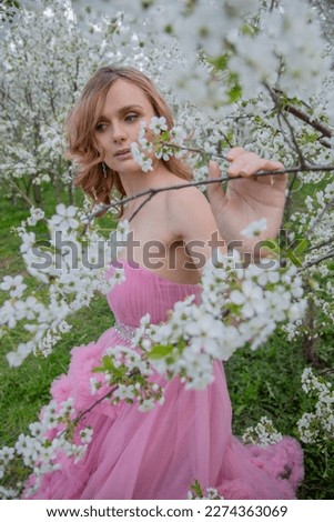 Portrait of a girl in a blooming garden. Blooming trees, traditional asian, travel, seasonal april background.