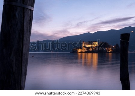 View from the port of Orta to the island of San Giulio, an important tourist destination in piedmont. Glimpses of the historic centre of Orta San Giulio, 
Lake Orta, Novara, Piedmont, 