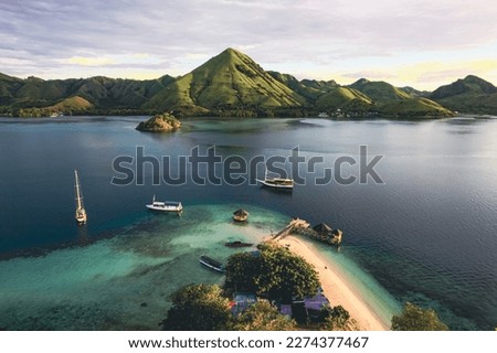 Beautiful aerial view of turquoise water with wooden pier, indonesioan