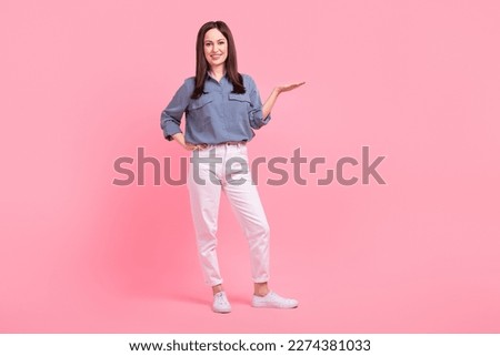 Full length photo of adorable positive lady wear trendy clothes arm presenting empty space special deal isolated on pink color background