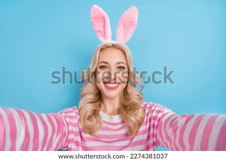Photo of shiny cute woman wear striped sweater bunny headband recording self video isolated blue color background