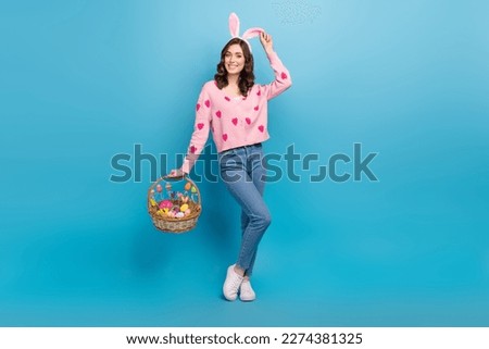 Full size photo of pretty girl hold easter eggs basket dressed stylish pink strawberry print clothes isolated on blue color background Royalty-Free Stock Photo #2274381325