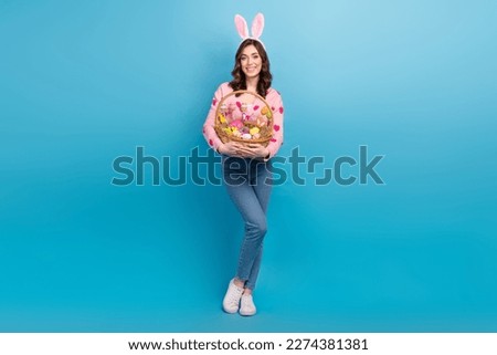 Full length photo of lovely lady easter bunny decoration wear trendy pink strawberry print garment isolated on blue color background Royalty-Free Stock Photo #2274381381