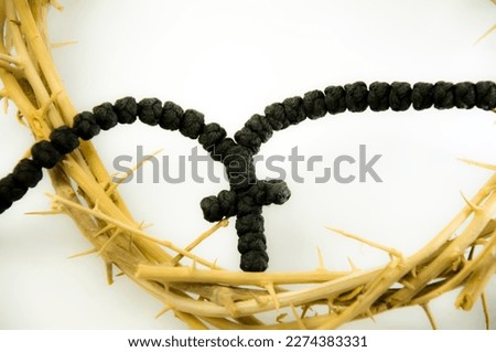 Close up view of Crown of thorns and rosary. Concept for faith, spirituality and religion.
