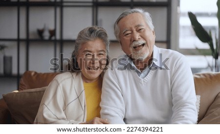 Portrait happy Asian mature senior couple look at the camera and smiling.