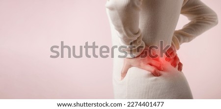 Young woman have back ache, waist pain, lumbar muscle injury problem. Office syndrome disease sick. Healthcare concept. Royalty-Free Stock Photo #2274401477
