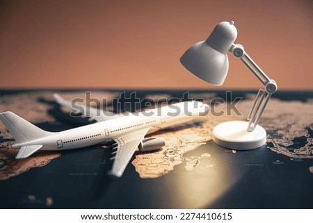 A small table lamp and a plane on a world map.