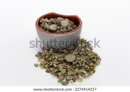 Origanum dictamnus, Dittany of Crete tea in a bowl on a white background. Cretan dittany or hop marjoram is a medicinal tea growing wild only in Crete. It is a healing, therapeutic and aromatic plant Royalty-Free Stock Photo #2274414217