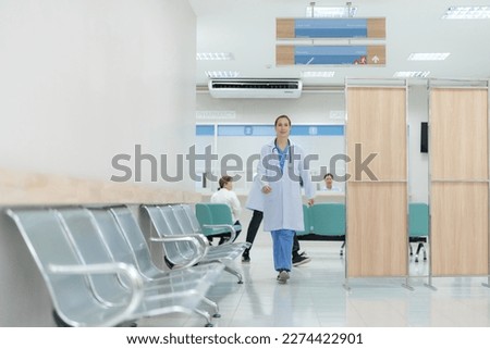 Doctor doing different poses in hospital with smiling face bright and friendly.