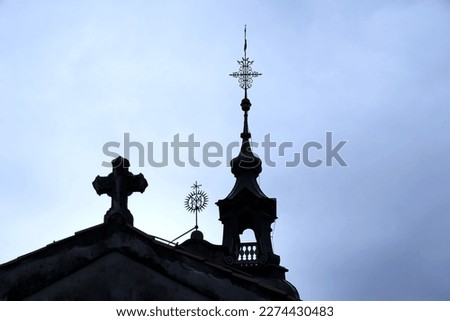 Cross and belfry silhouette in front of cloudy sky in Catholic church in Shrine of our Lady Trsat Royalty-Free Stock Photo #2274430483