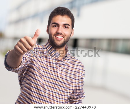 portrait of a handsome young man with thumb up