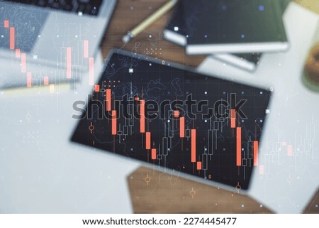 Creative abstract economic crisis chart with world map hologram and modern digital tablet on desktop on background, top view, bankruptcy and recession concept. Multiexposure