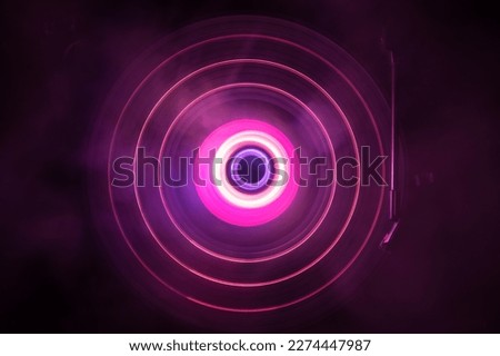 Music Dj concept. Trail of fire and smoke on vinyl record. Burning vinyl disk. Turntable vinyl record player on dark background. Selective focus Royalty-Free Stock Photo #2274447987
