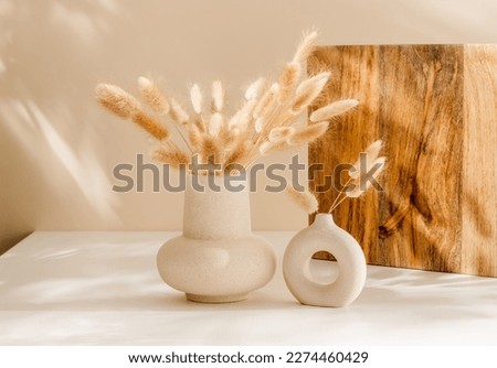 Bohemian vase set with dry lagurus grass on the table with shadows. Scandinavian cozy interior decoration, aesthetic home poster Royalty-Free Stock Photo #2274460429
