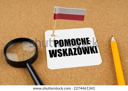 On the table is the flag of Poland, a pencil, a magnifying glass and a sheet of paper with an inscription in Polish which translates into English as - Helpful Tips
