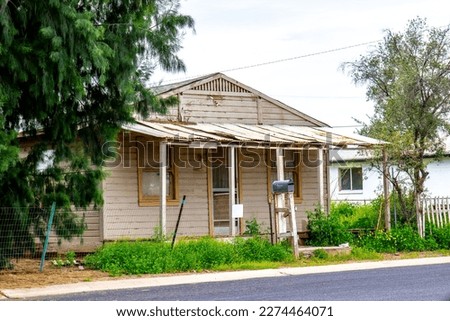 Abandoned Home With Overgrown Weeds Royalty-Free Stock Photo #2274464071