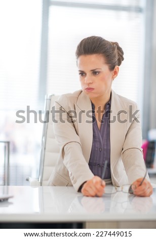 Portrait of concerned business woman with eyeglasses in office